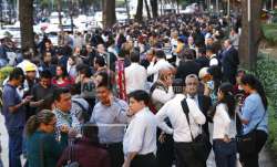 People stand along Reforma Avenue after a 7.2-magnitude