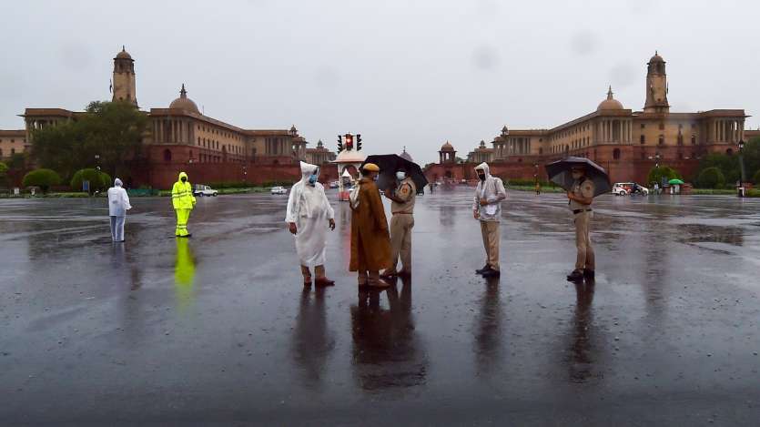 Security personnel stand guard at Vijay Chowk during heavy rains, in New Delhi.